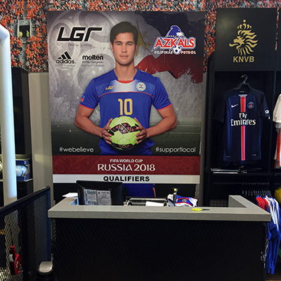 Phil Younghusband poster behind the BootCamp cashier
